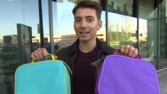 Ricky holding two packed lunch boxes