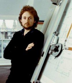 Rick Dickinson stands next to drawing board used to design the ZX Spectrum