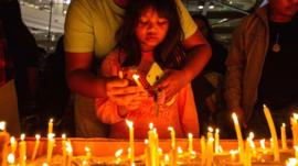 Thai mourners lighting candles