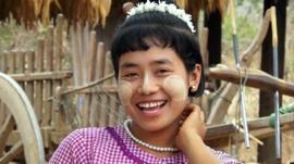 Burmese woman has tucks her hair behind her ears to show she is ready to date.