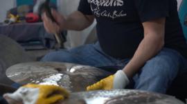 Man hammering a cymbal in workshop