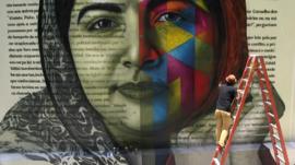 Street artist Kobra painting a mural