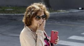 A relative of a person who was flying aboard the Chilean Air Force C-130 Hercules cargo plane that went missing in the sea between the southern tip of South America and Antarctica on December 9, 2019 gestures at the Cerrillos base in Santiago, on December 10, 2019.