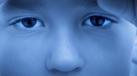 Stock image - close up of a child's eyes looking sad