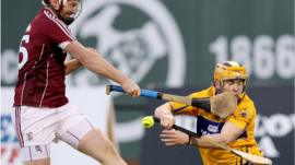 Tony Kelly of Clare is hit in the face by John Hanbury of Galway during the 2017 AIG Fenway Hurling Classic and Irish Festival at Fenway Park