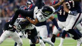Carlos Hyde #34 of the Jacksonville Jaguars collides with Keelan Cole #84 in the fourth quarter against the Houston Texans at NRG Stadium on December 30, 2018 in Houston, Texas.