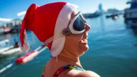 A woman takes part in the traditional Nadal CUp Christmas swimming event at the port in Barcelona, Spain,