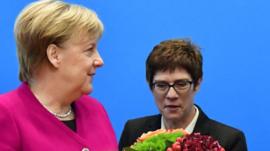 German Chancellor and leader of the Christian Democratic Union (CDU) Angela Merkel (L) receives flowers next to CDU's Secretary General Annegret Kramp-Karrenbauer before a CDU leadership meeting at the party's headquarters on October 29, 2018 in Berlin