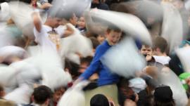 Revellers take part in a giant pillow fight in Trafalgar Square on 'International Pillow Fight Day' on April 4, 2015 in London, England.