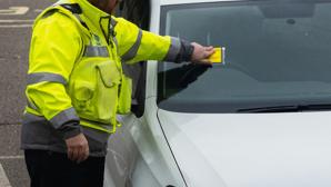 Warden issuing a parking ticket