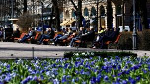 People enjoy a sunny day on the Esplanade in Helsinki, Finland, in May 2017