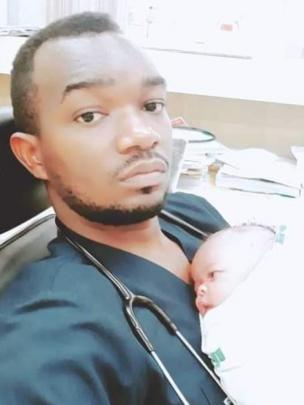 Osmand holding a new-born
