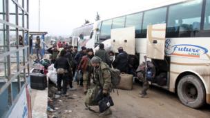 Syrian rebel fighters, arrive in the opposition-controlled Khan al-Assal region, west of Aleppo after being evacuated from the embattled city
