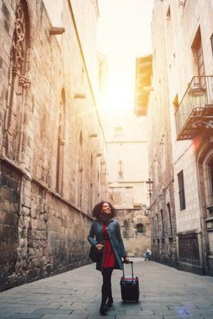 Young female tourist walking on an old street in Barcelona, Catalonia