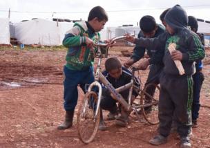 Children playing with a bike