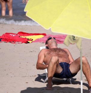 A man sunbathes in the sun