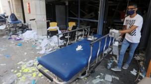 A man wearing a face mask moves a gurney at a damaged hospital following Tuesday"s blast in Beirut, Lebanon August 5, 2020.