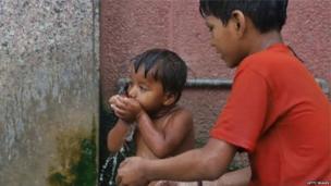 पानी पीता हुआ एक बच्चा