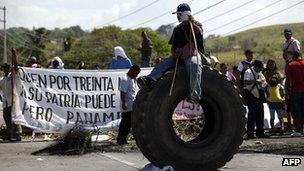 Indigenous Panamanians block the pan-American Highway in protest against planned changes to the mining laws