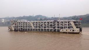 A car transporter is filled with the same model of white cars