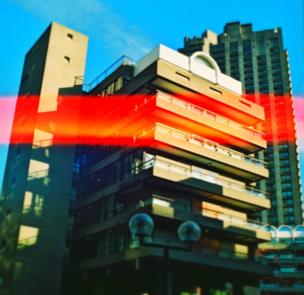 A tower block with a streak of red light across it