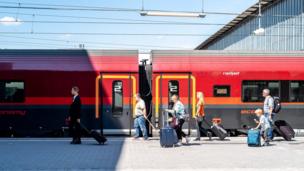 Passengers beside a train