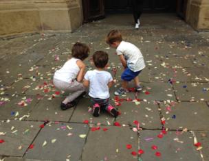 Children play with confetti on the ground