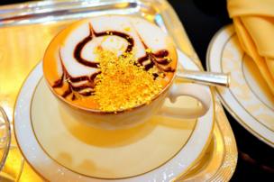 A cup of coffee with gold flake