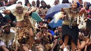 South African President Jacob Zuma (L) sings and dances with his newlywed Tobeka Madiba (R) at their wedding ceremony on January 4, 2010 in a colourful Zulu traditional wedding outfit at Zuma's rural homestead of Nkandla