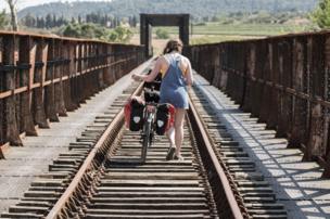 Pushing a bike across a railway bridge