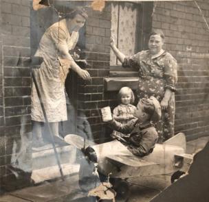 An old photograph of a young boy collecting money for the Sheffield air force during World War Two.