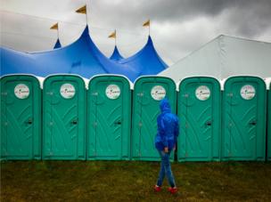 A woman queues for the toilets