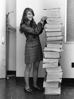 Margaret Hamilton with a stack of code