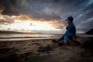 Child looking at a sunset