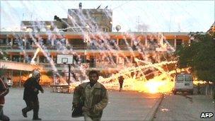 Palestinians running for safety as white phosphorus lands on a UN-run school in Beit Lahia (file photo 17 January 2009)