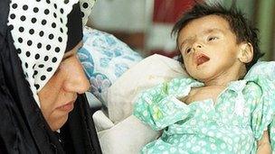 A sick baby in a Baghdad hospital (File photo September 1999)