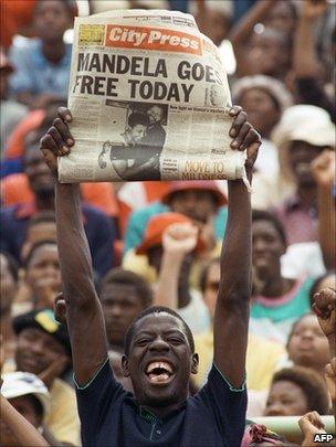 Man holding newspaper on the day Nelson Mandela was set free