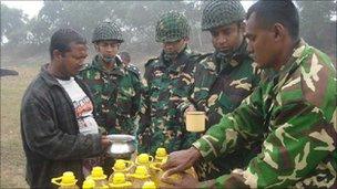 Soldiers distributing Soya bin Oil
