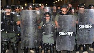 Sheriff"s deputies form a defensive line outside the office of Sheriff Joe Arpaio, 29 July