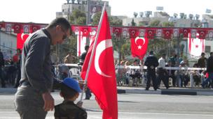 A little boy holds a Turkish flag in Cyprus