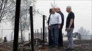 Vladimir Putin and officials visiting fire damaged village