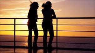 Two teenage girls watching sunset