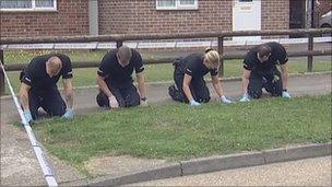 Forensic officers search for clues