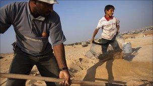 Saleh al-Dama, 38, and son Ali, 11, dig for gravel in Beit Lahiya, Gaza Strip, July 2010