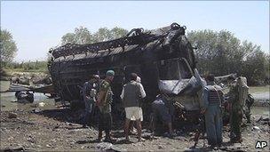 Afghan police inspect the burned tanker in Kunduz