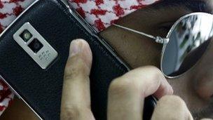 A Saudi man speaks on his Blackberry