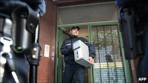 Police officer removes computer from Taiba mosque in Hamburg, 9 Aug 10