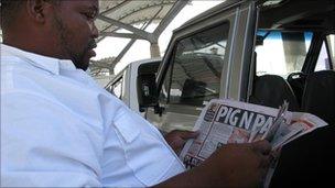 A minibus taxi reading a newspaper in Cape Town