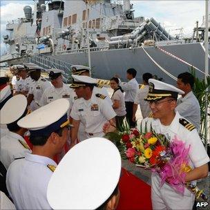 US commander Jeffrey Kim (R) and his crew are greeted by Vietnamese naval officers at Tien Sa port in the central coastal city of Danang