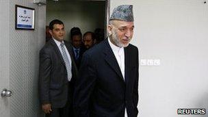 Afghan President Hamid Karzai arrives for his speech to the Civil Services Institute in Kabul, 7 August